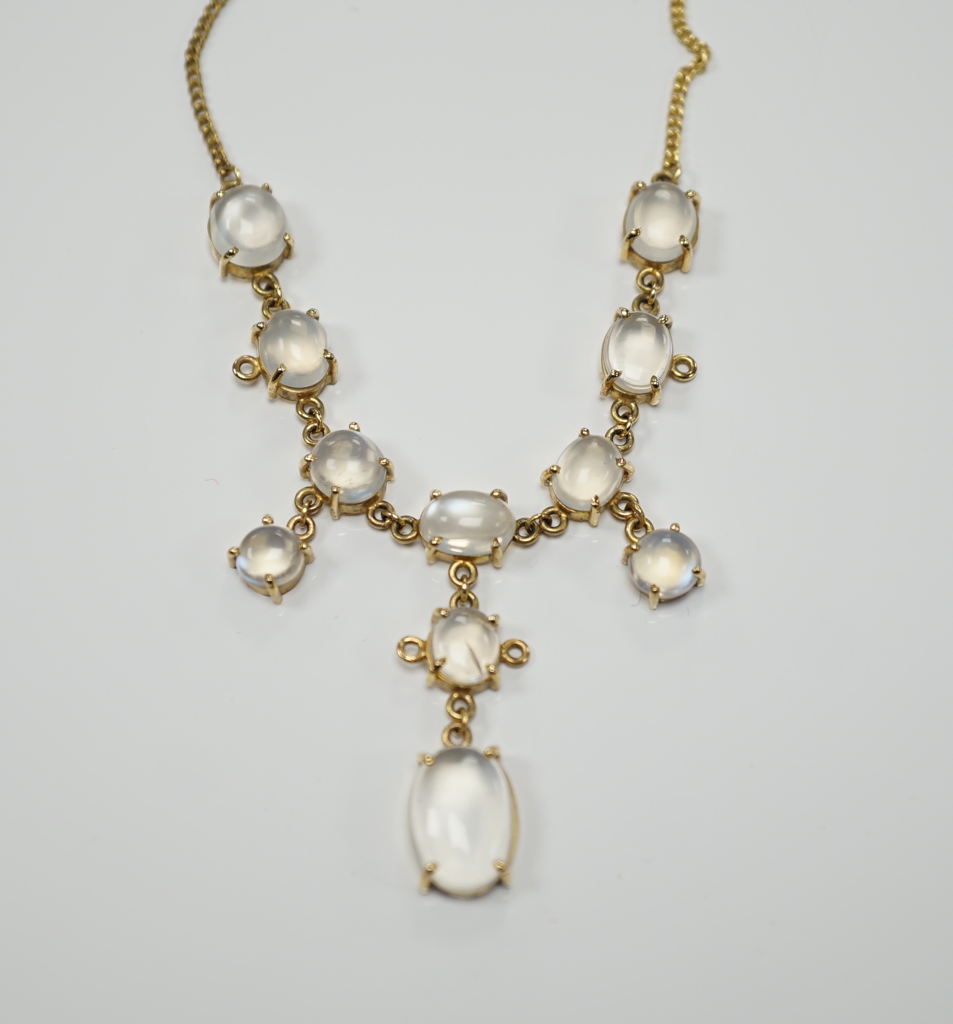 An Edwardian style 9k and cabochon moonstone cluster set drop necklace, 48cm, gross weight 11.2 grams.